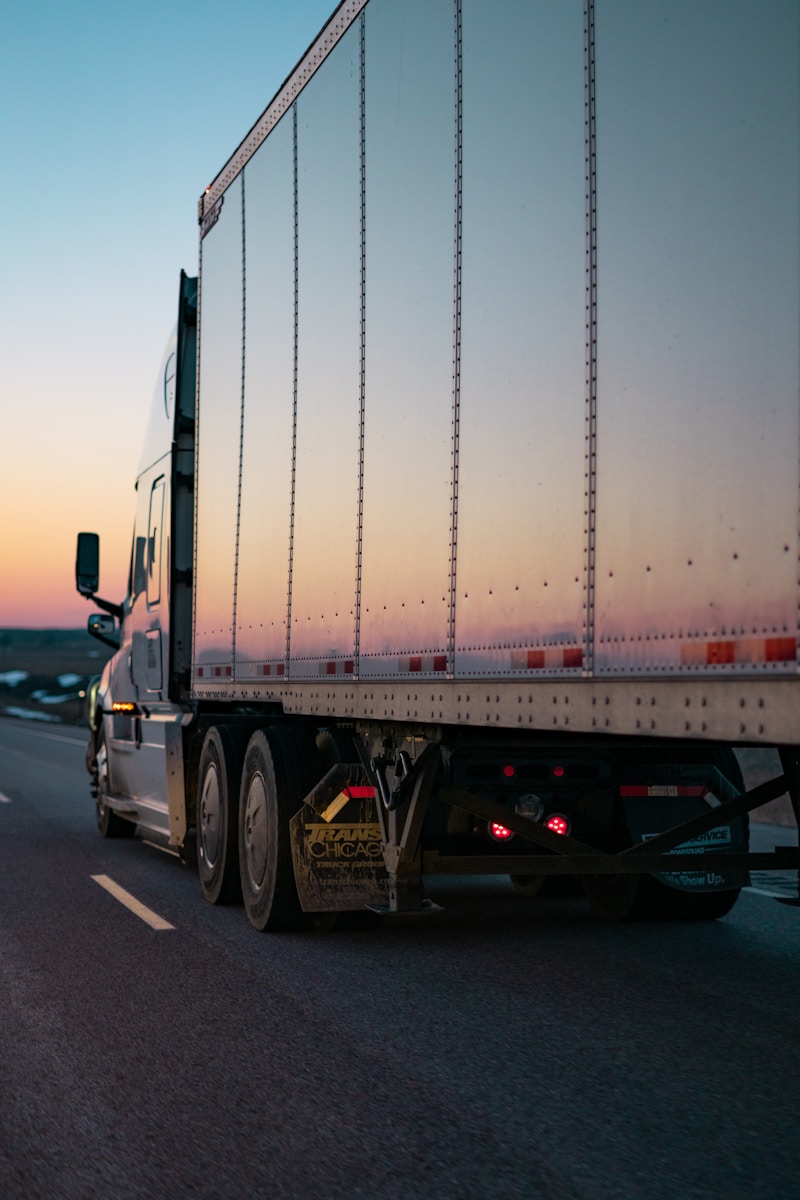 Photo by Caleb Ruiter white freight truck on road during daytime